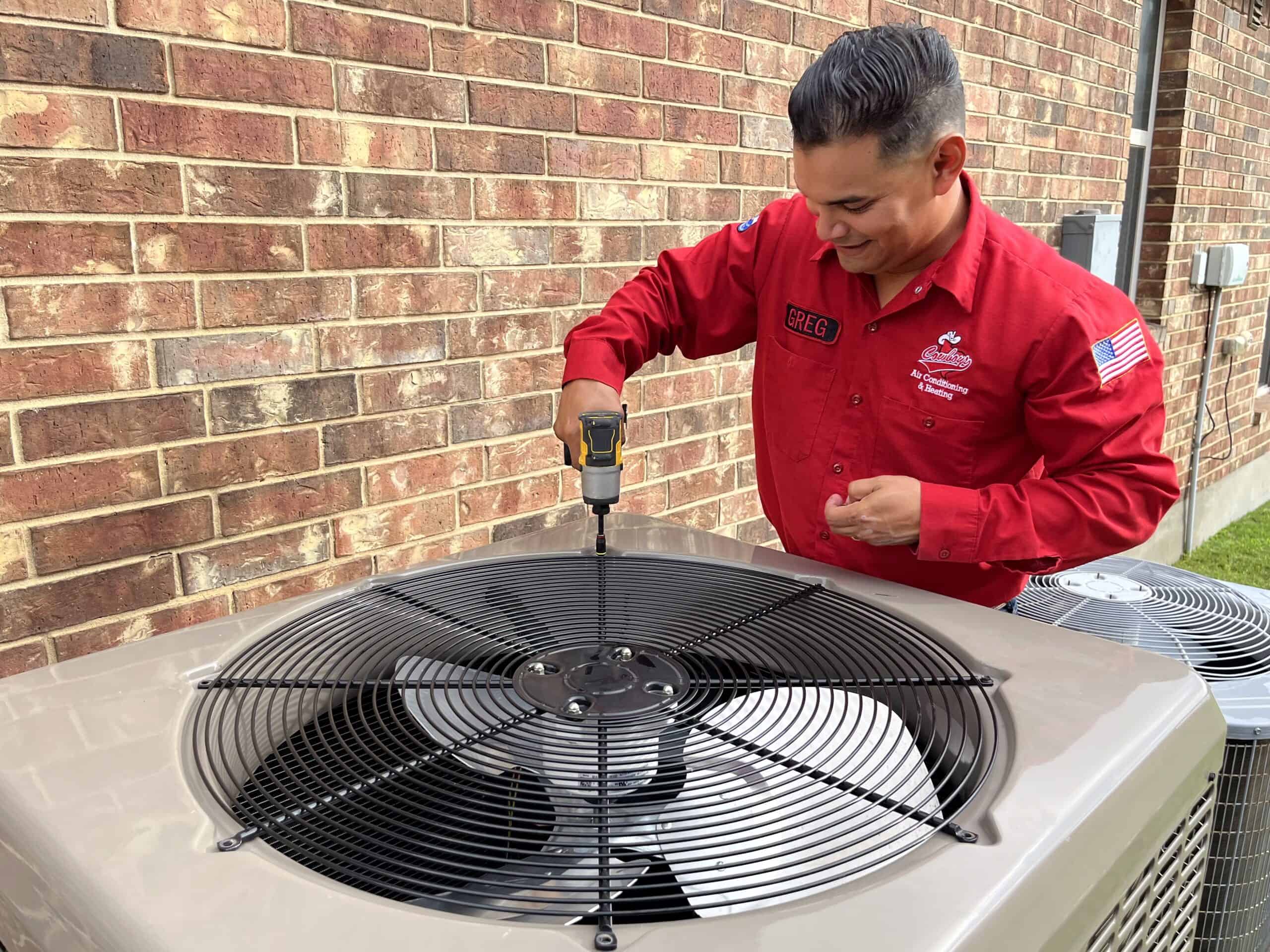 Cowboys tech repairing AC unit