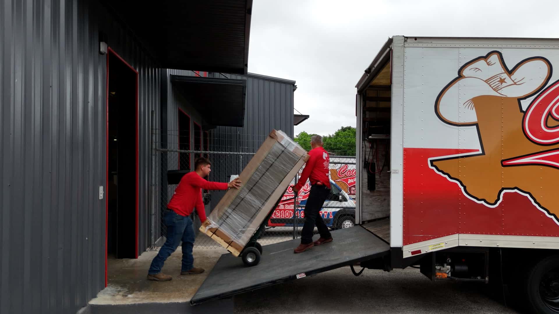 Cowboy's crew unloading a new Trane system from the box truck