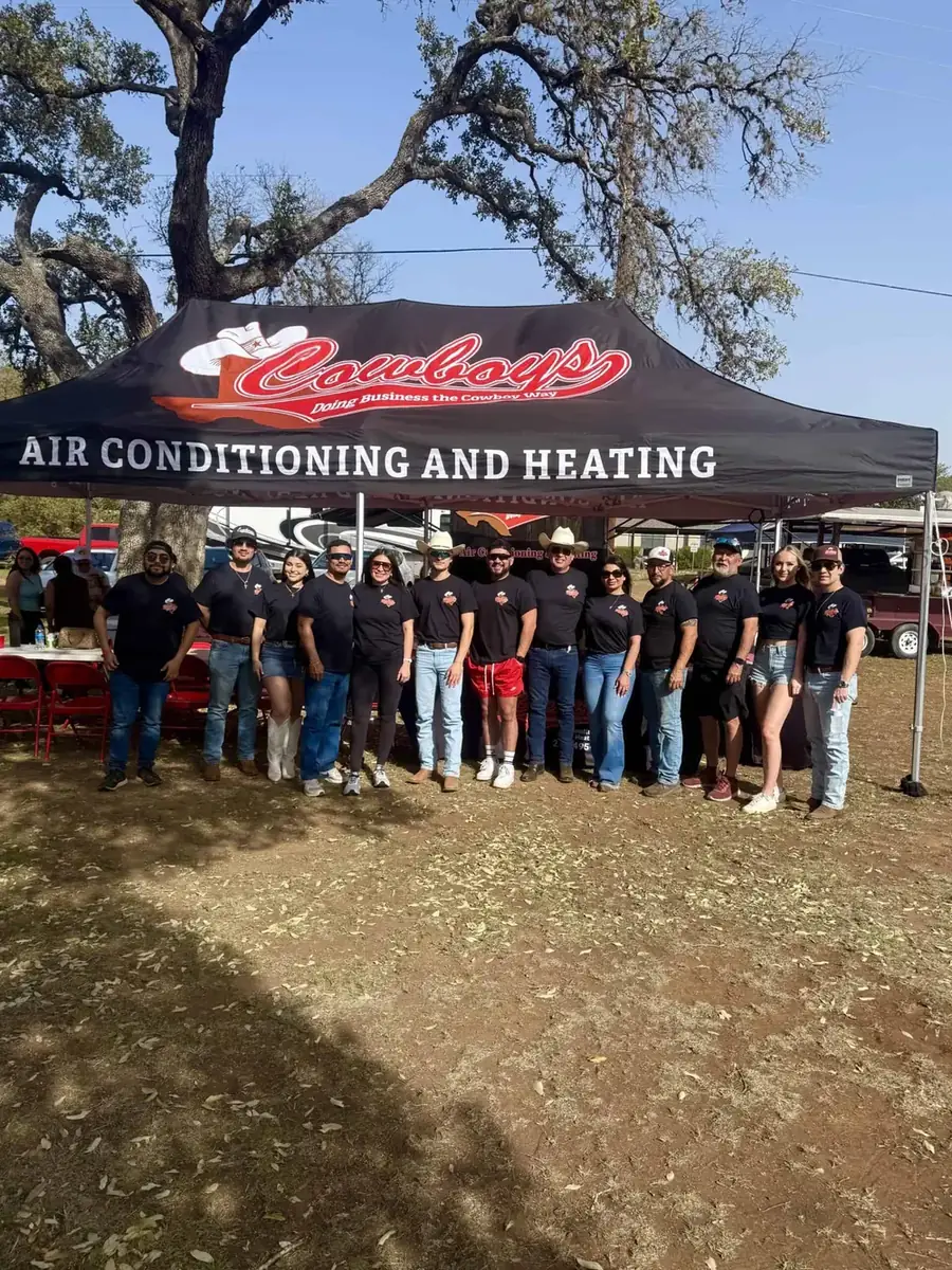 The Cowboy's team under a branded tent at a community event
