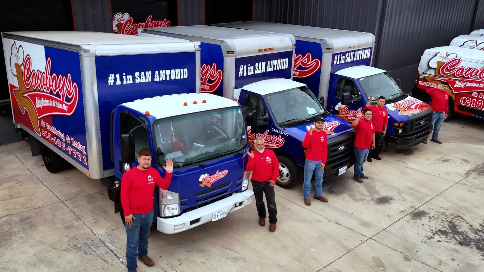 Cowboy's technicians standing beside their branded trucks