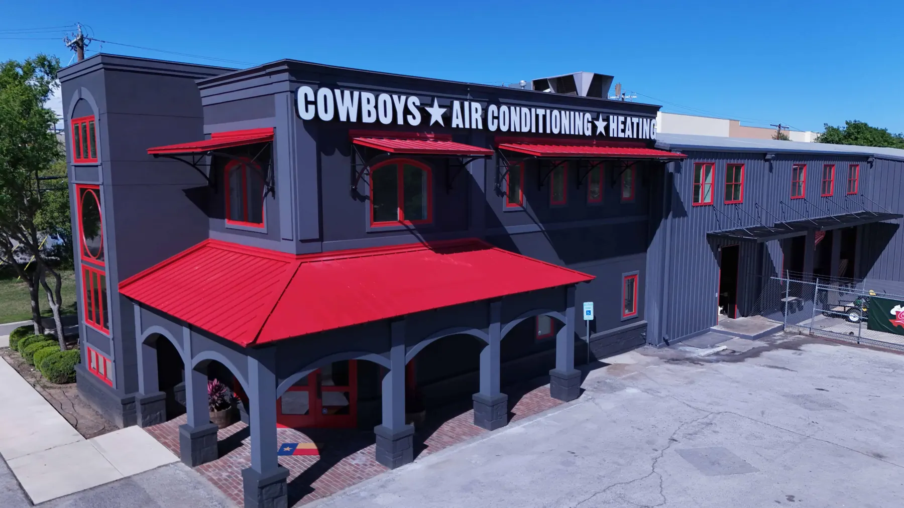 Aerial view of Cowboy's headquarters, grey with red awnings, at 6510 Blanco Road